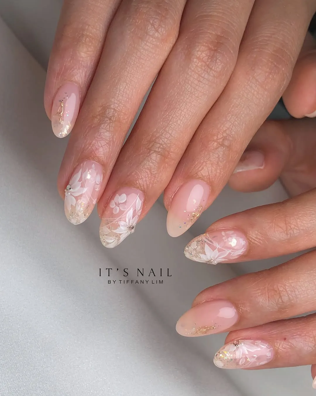 Sheer nude florals with glittery, translucent tips