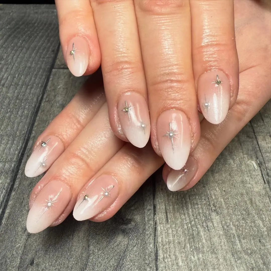 Nude-to-milky ombrΓ© with starburst and tiny bead accents