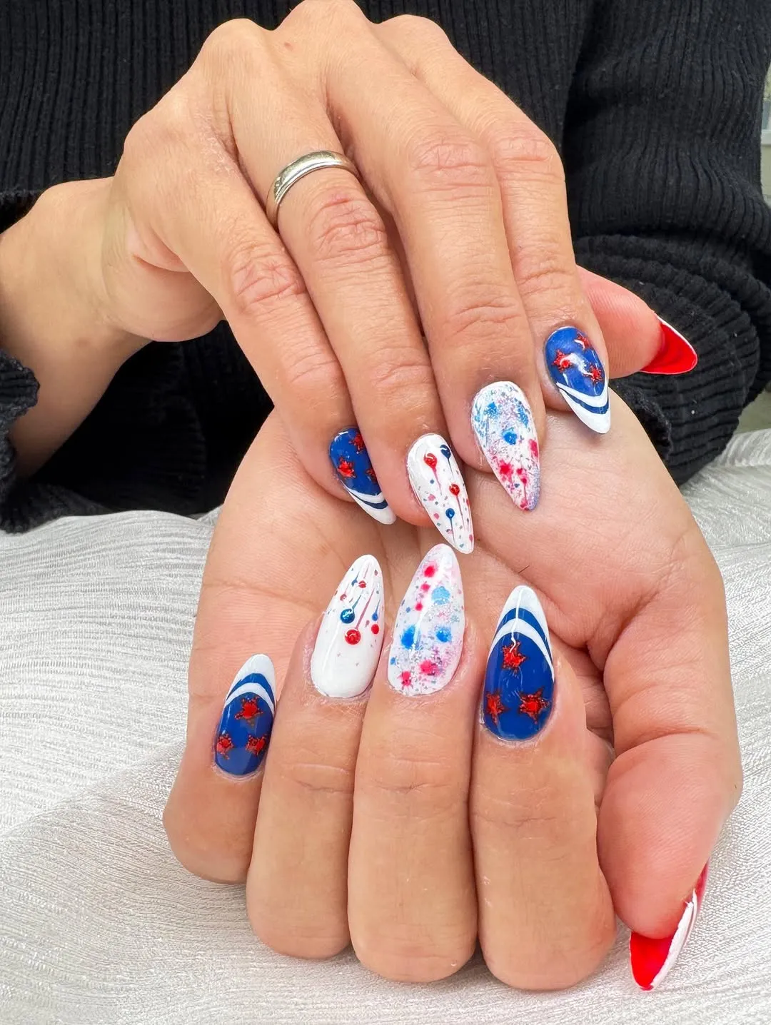Deep blue curved tips with red stars and paint-fleck accents