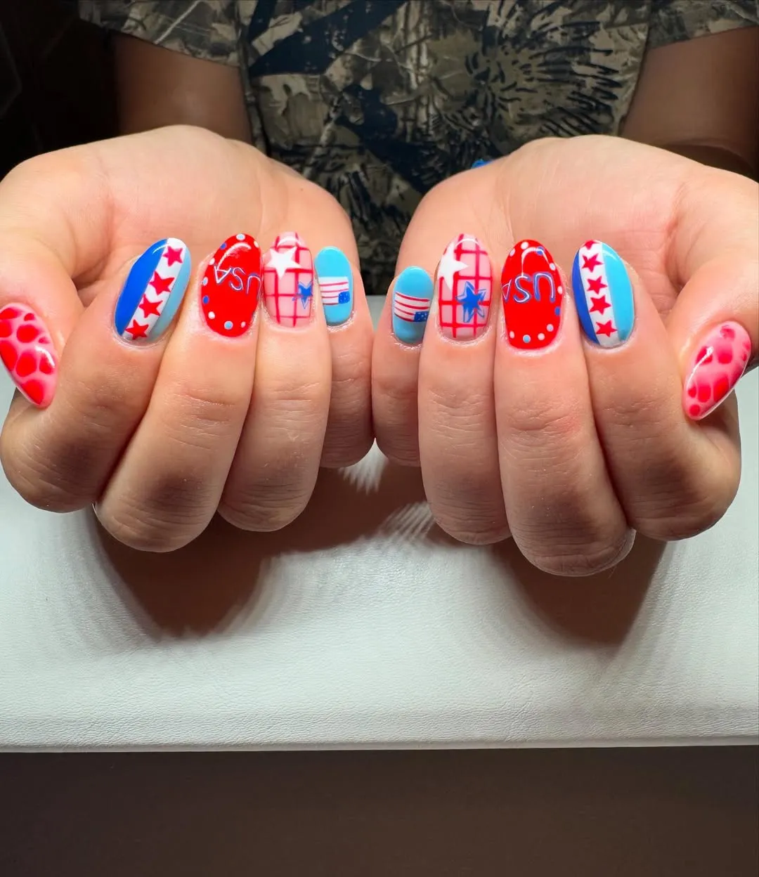 Graphic βUSAβ nails with grids, stars, and stripes
