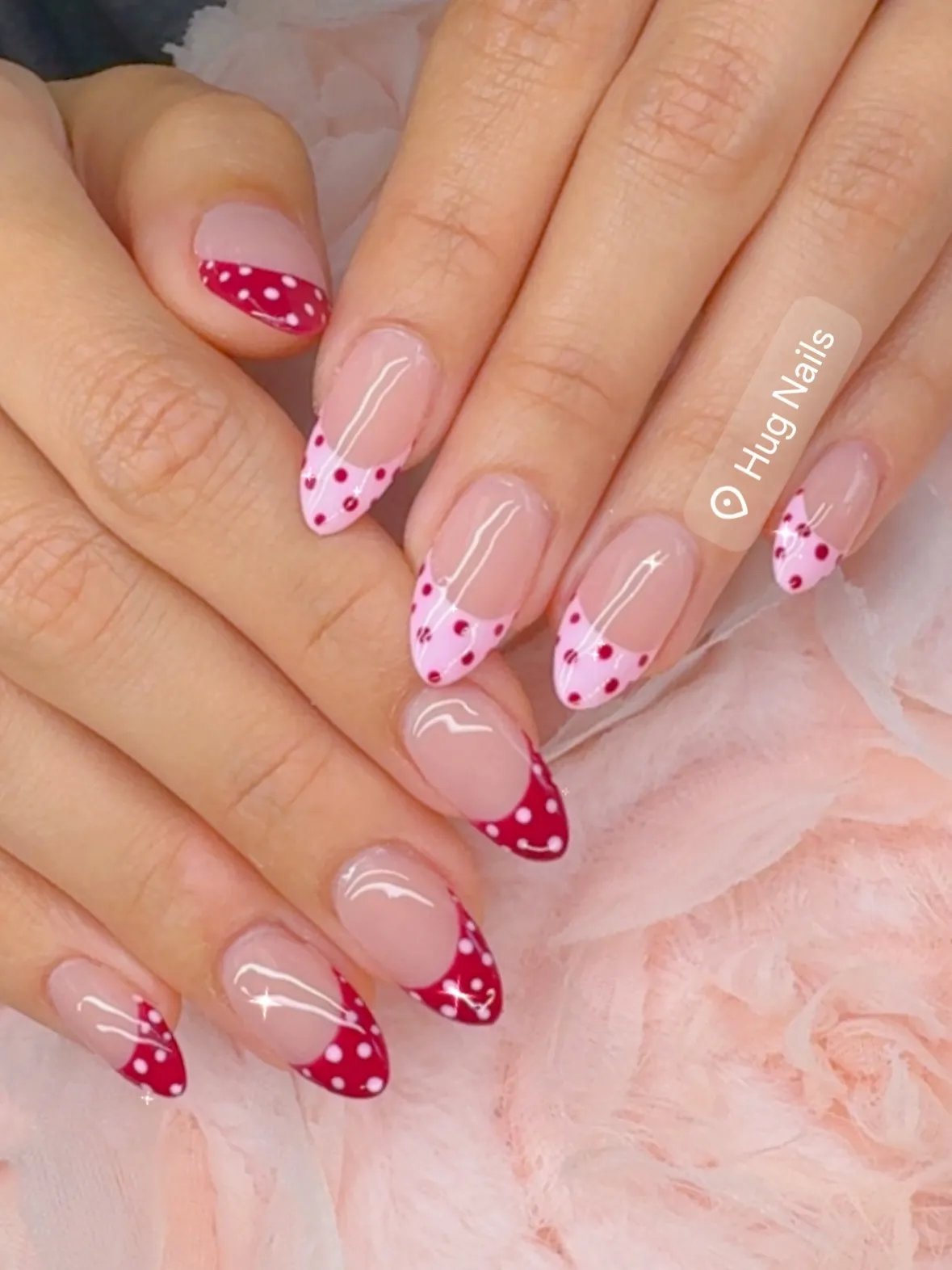 Red polka-dot French tips with a pink accent tip