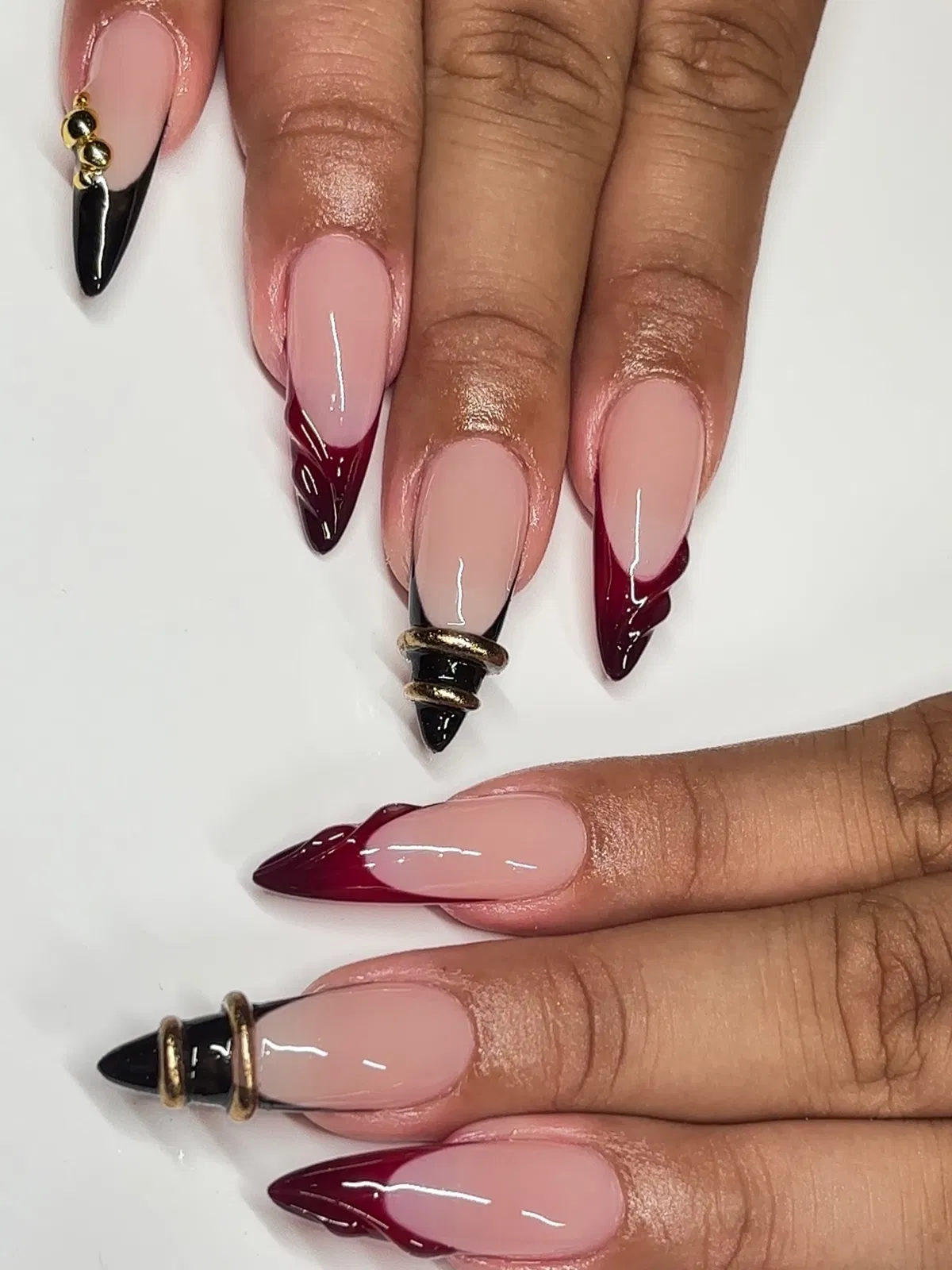 Nude stiletto base with cherry-and-black flame French tips