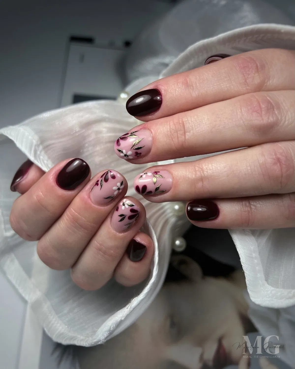Short dark cherry nails with delicate floral accents