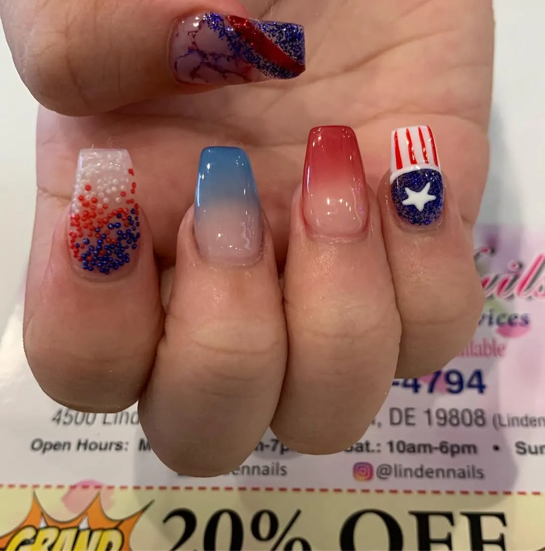 Gradient nails with glitter-star accent and beaded red/white/blue texture