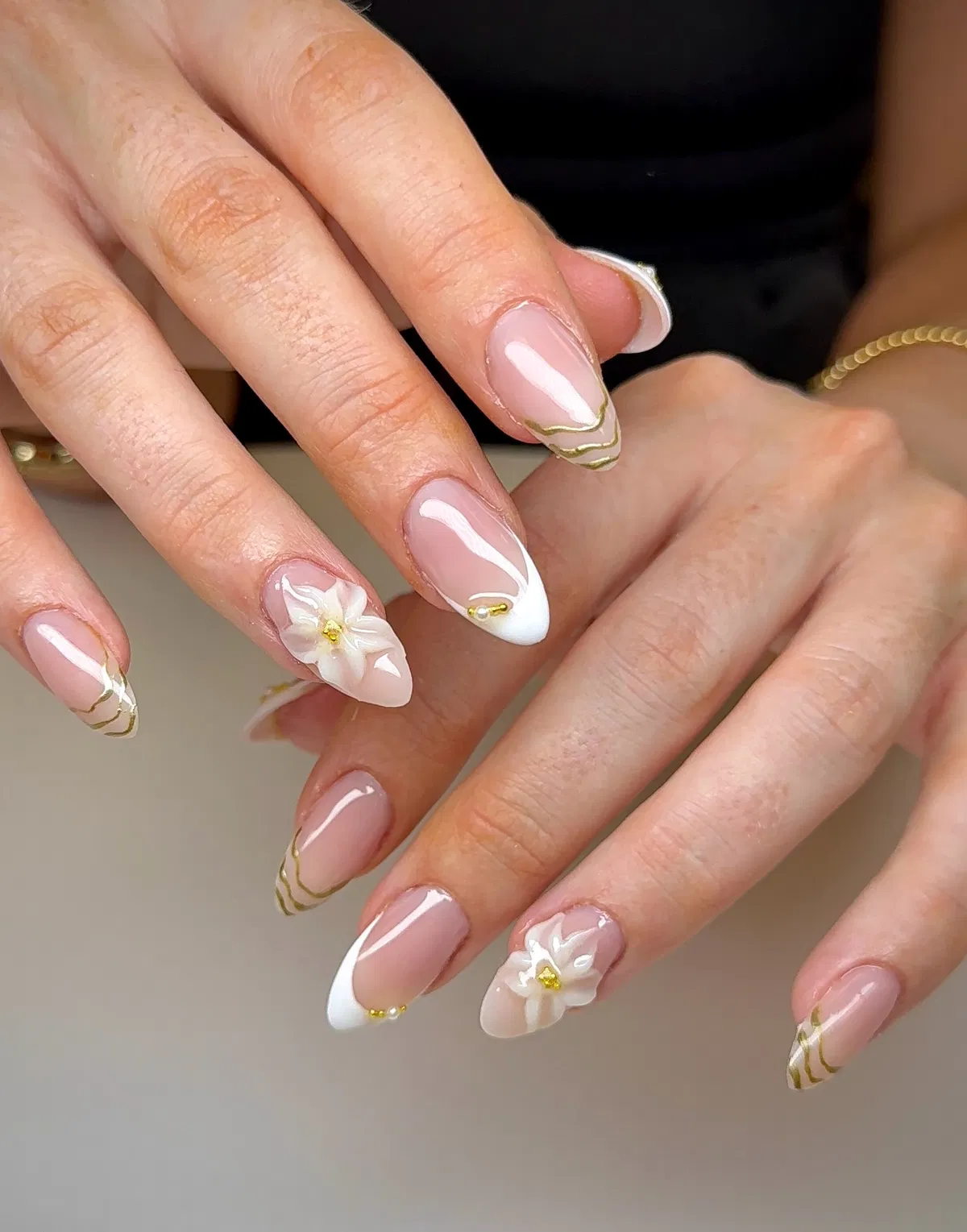 Gold-lined French tips with 3D white flower accents