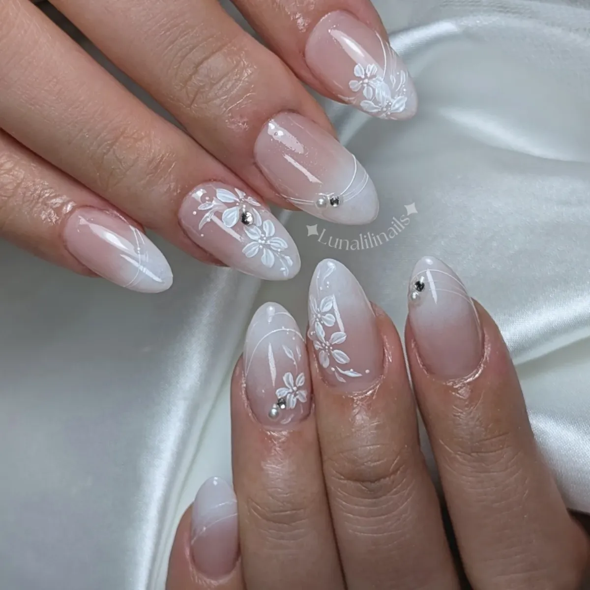 Pink-to-milky ombrΓ© with white florals and pearl accents