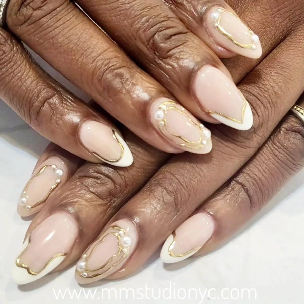 Soft-square French tips with gold edging and pearl accents