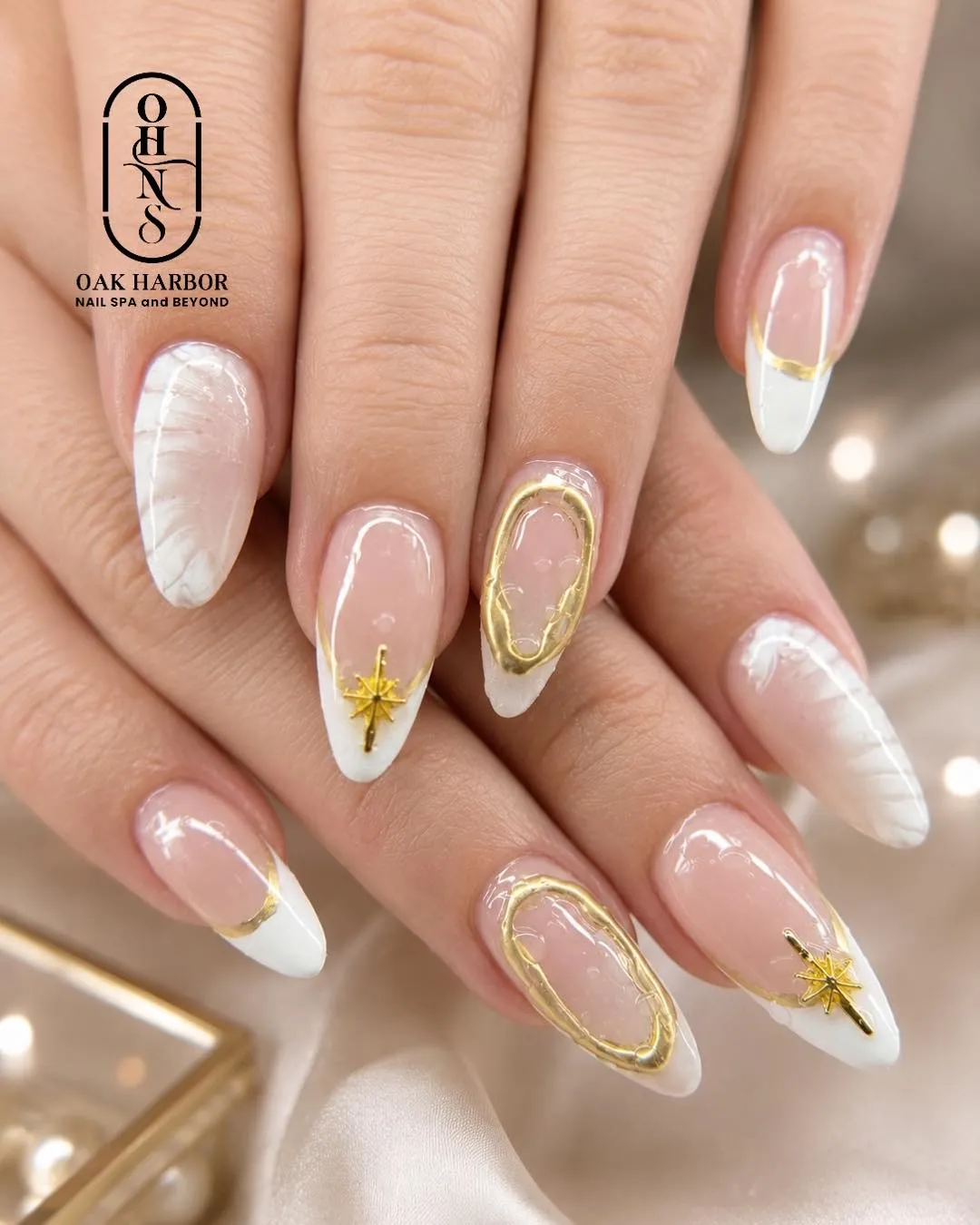 Almond French tips with gold frames and star charms
