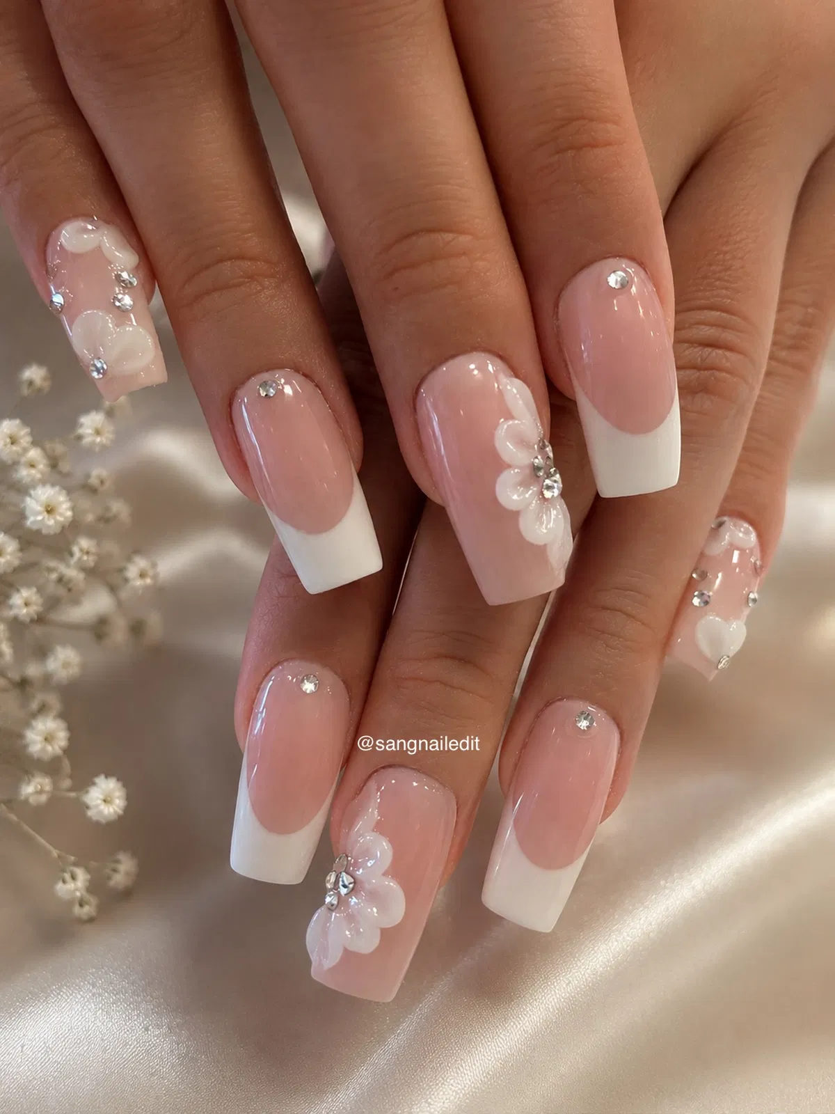 Square French tips with rhinestones and raised floral details