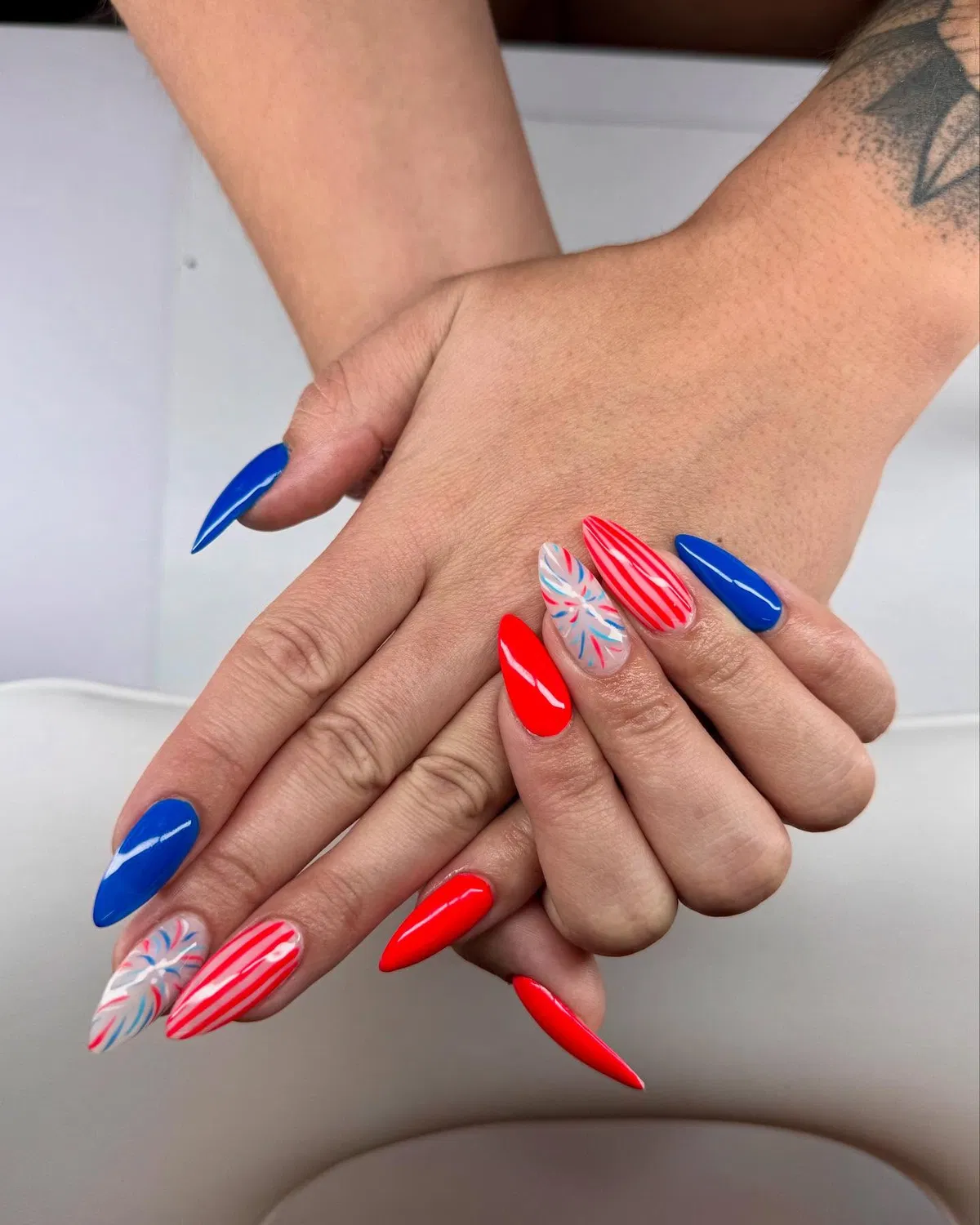 Bright red and blue stilettos with a single burst accent