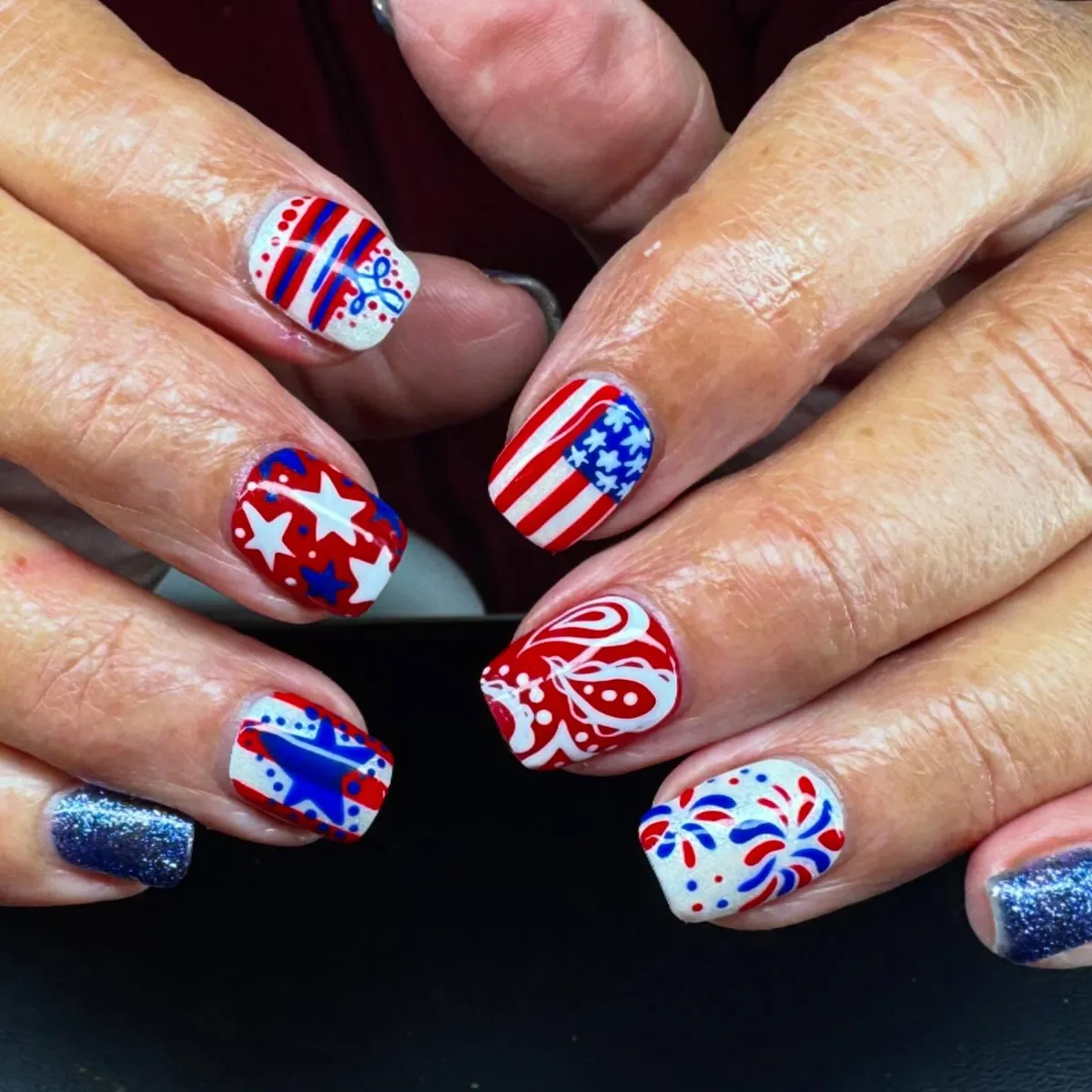 Stars, stripes, and dot accents on short square nails