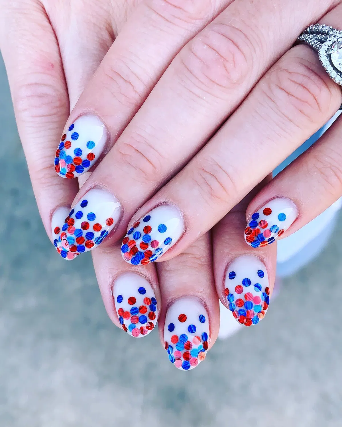White nails with red and blue confetti-dot tips