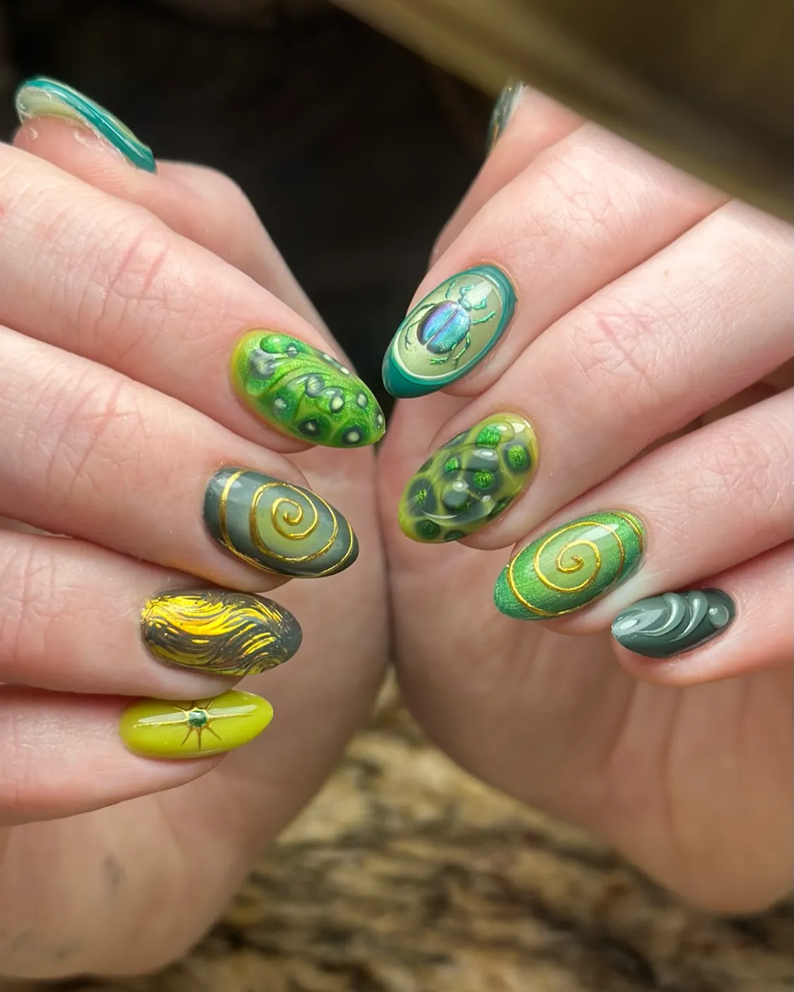 Green textures with gold spirals and a beetle accent