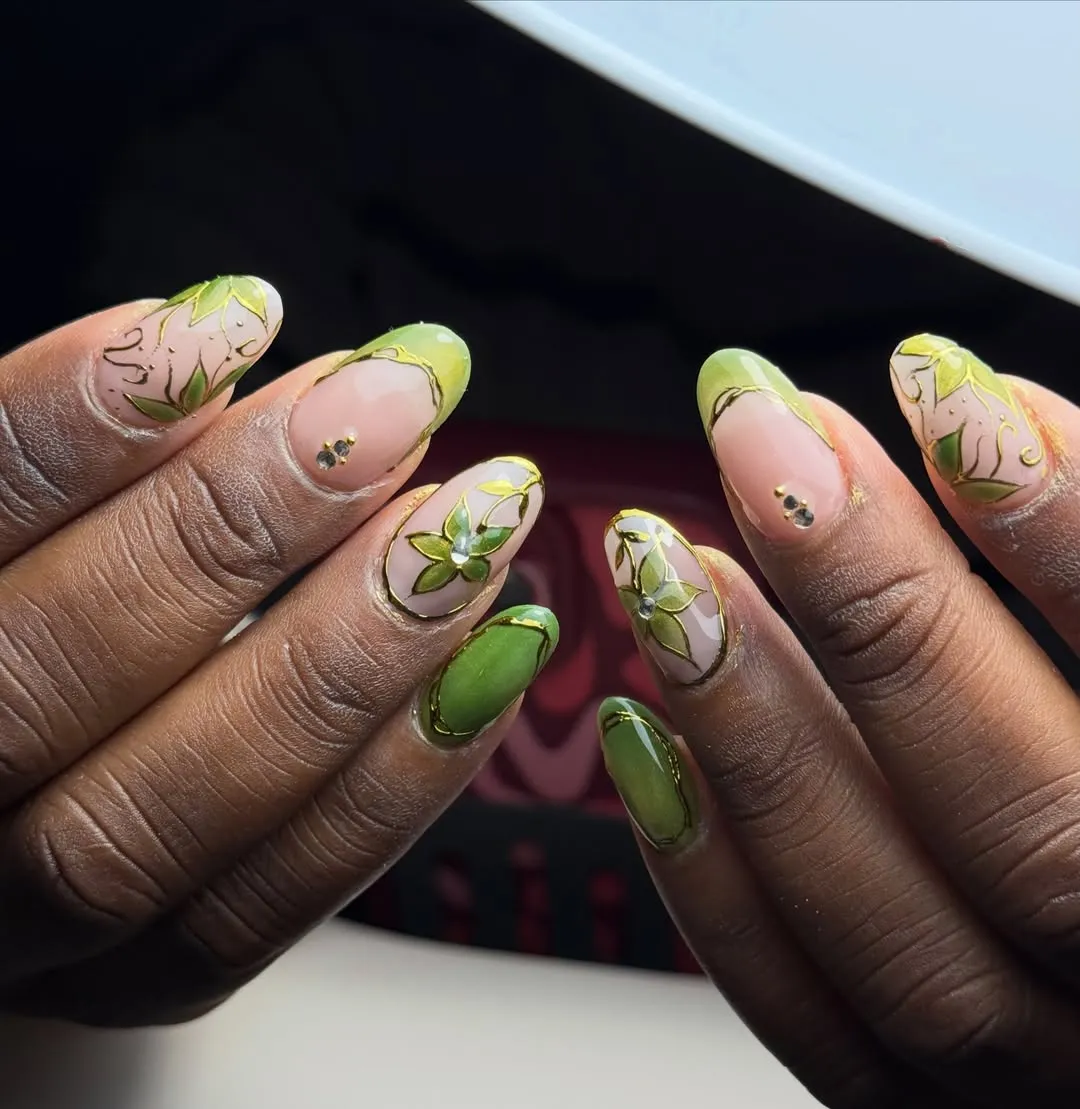 Light green French tips with gold outlines and floral line art