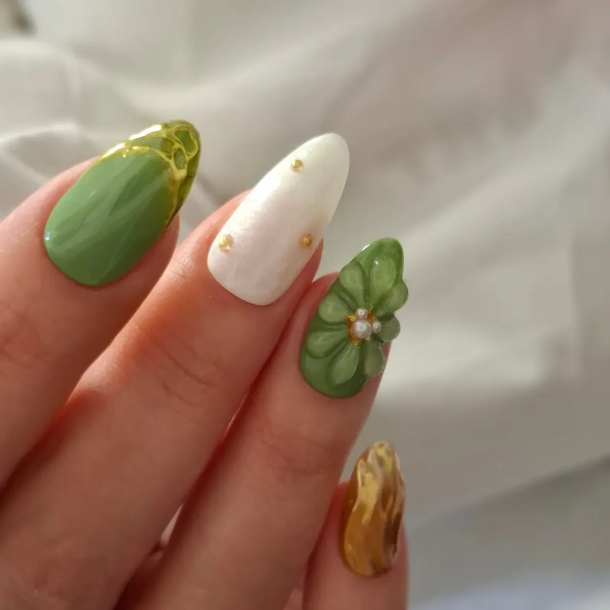 Green and white mix with gold studs and a raised flower accent