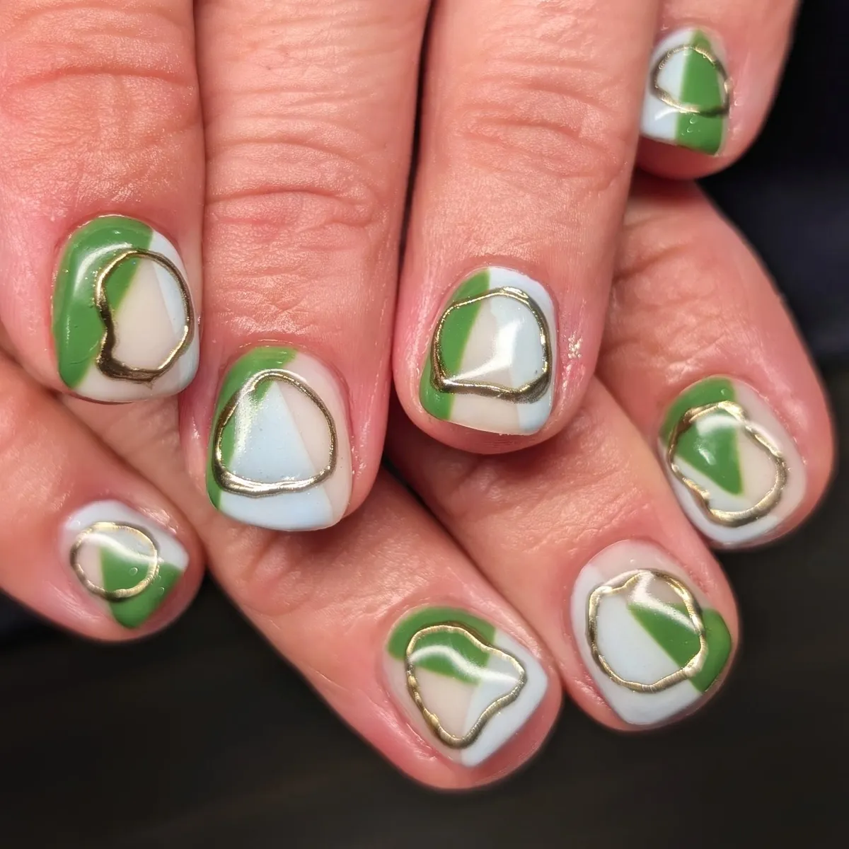 White and green blocks with irregular gold outline shapes