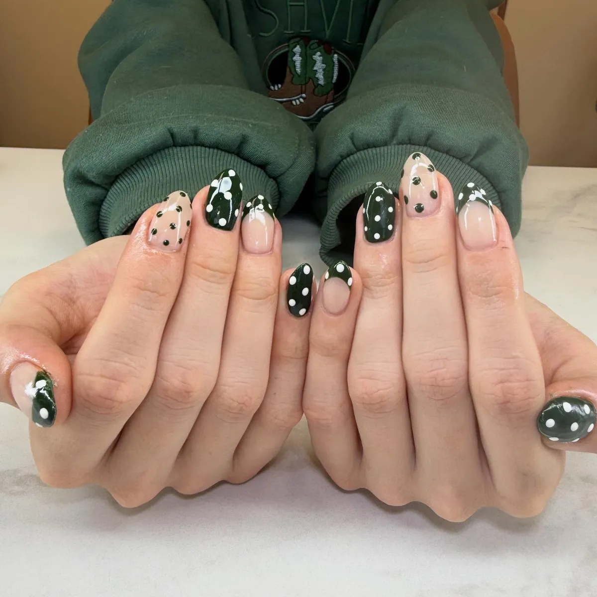 Dark green and nude polka-dot mix with French tips