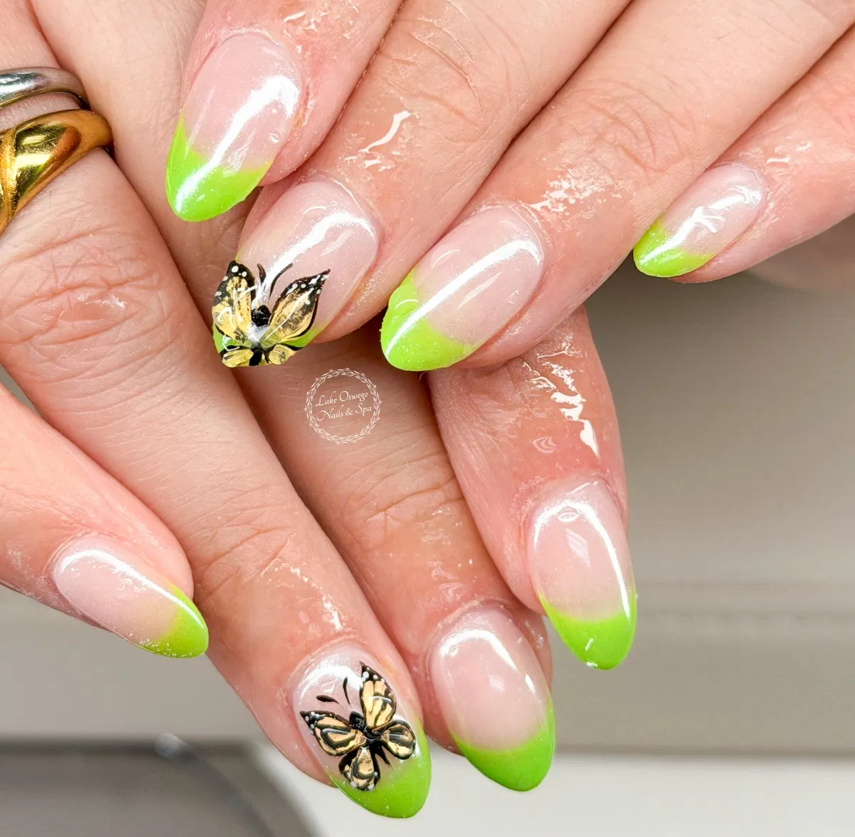 Soft lime French tips with butterfly accents