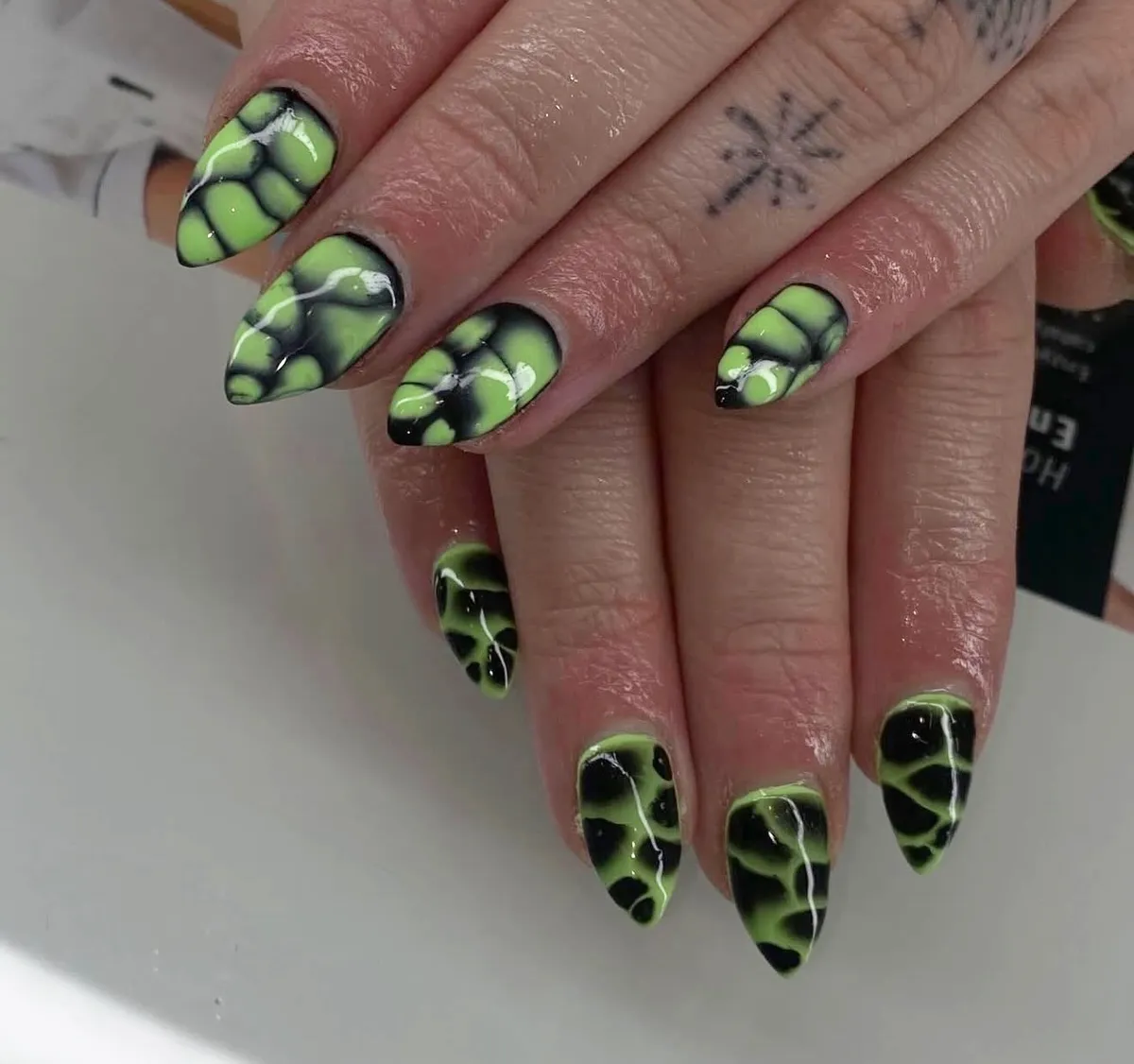 Lime green and black cell-pattern nails