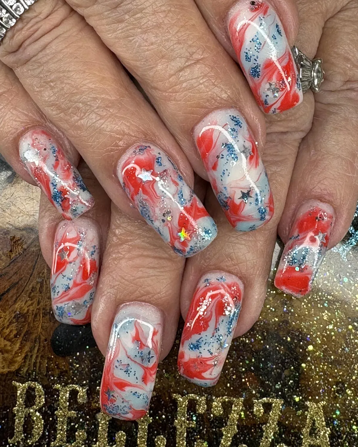 Red-and-white marbled swirls with blue speckling and star confetti