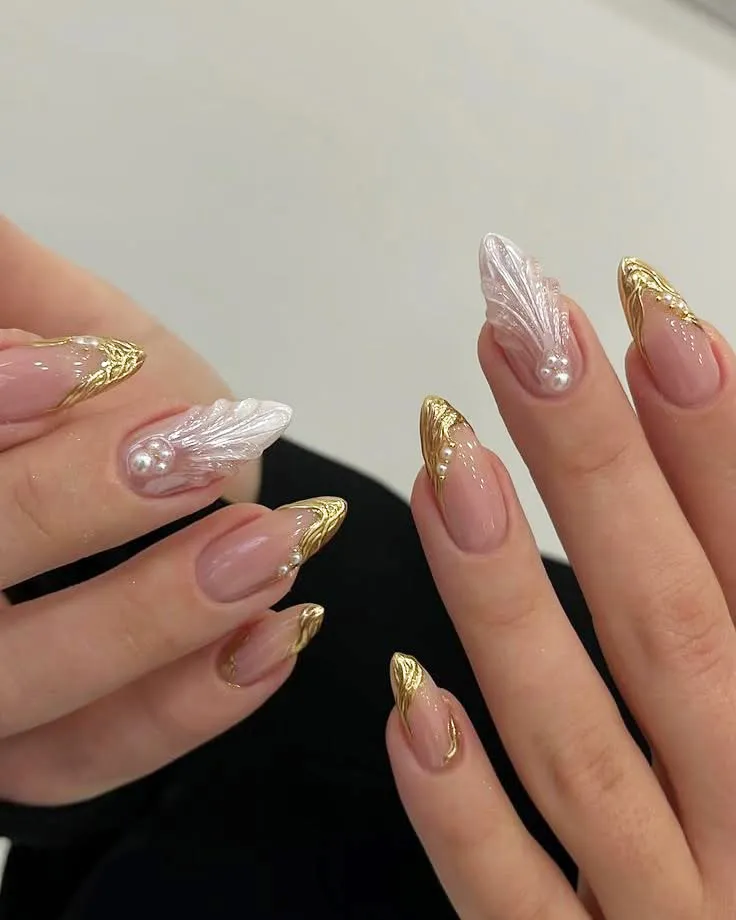 Gold-edged French tips with raised feather-like white accents