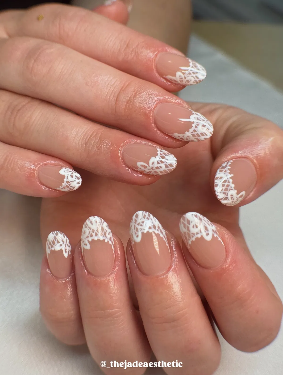 Nude nails with white lace corner tips