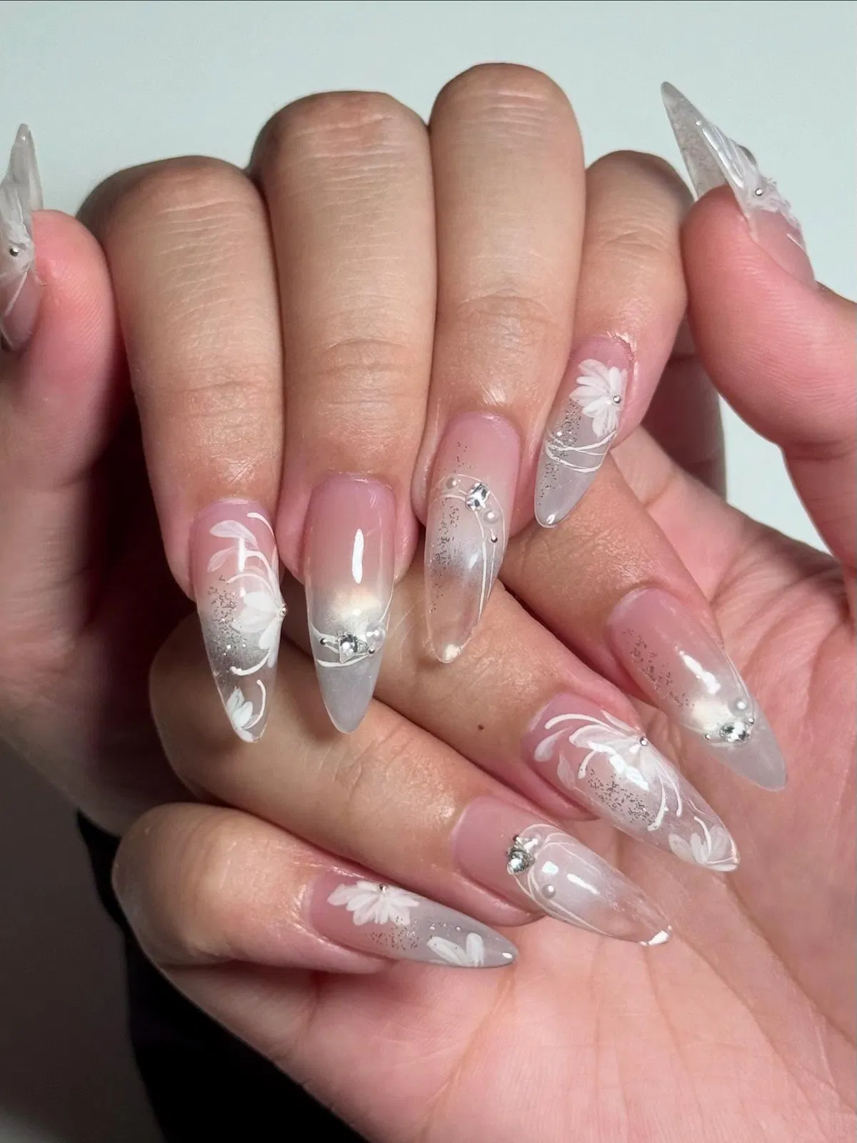 Sheer pink with translucent tips and white florals
