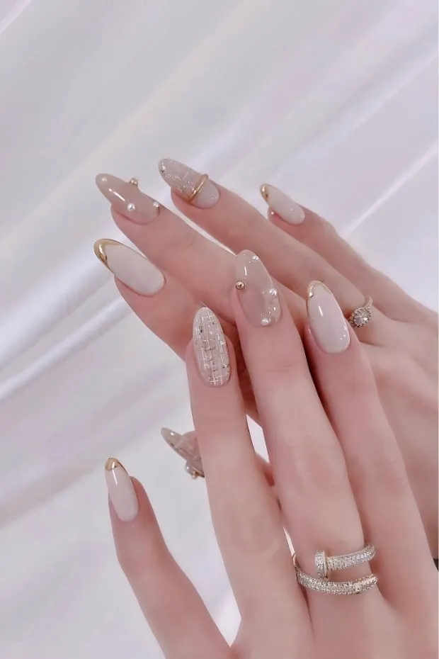 Cream nude with gold-edged tips and textured accent