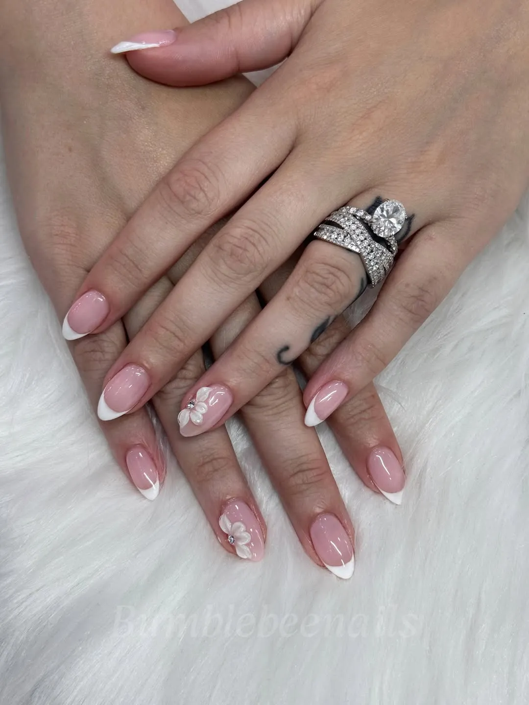 Pink French tips with raised floral accents