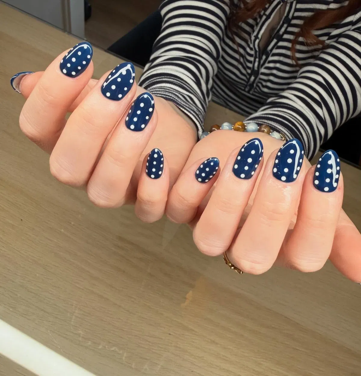 All-navy polka dots with subtle curved white line accents