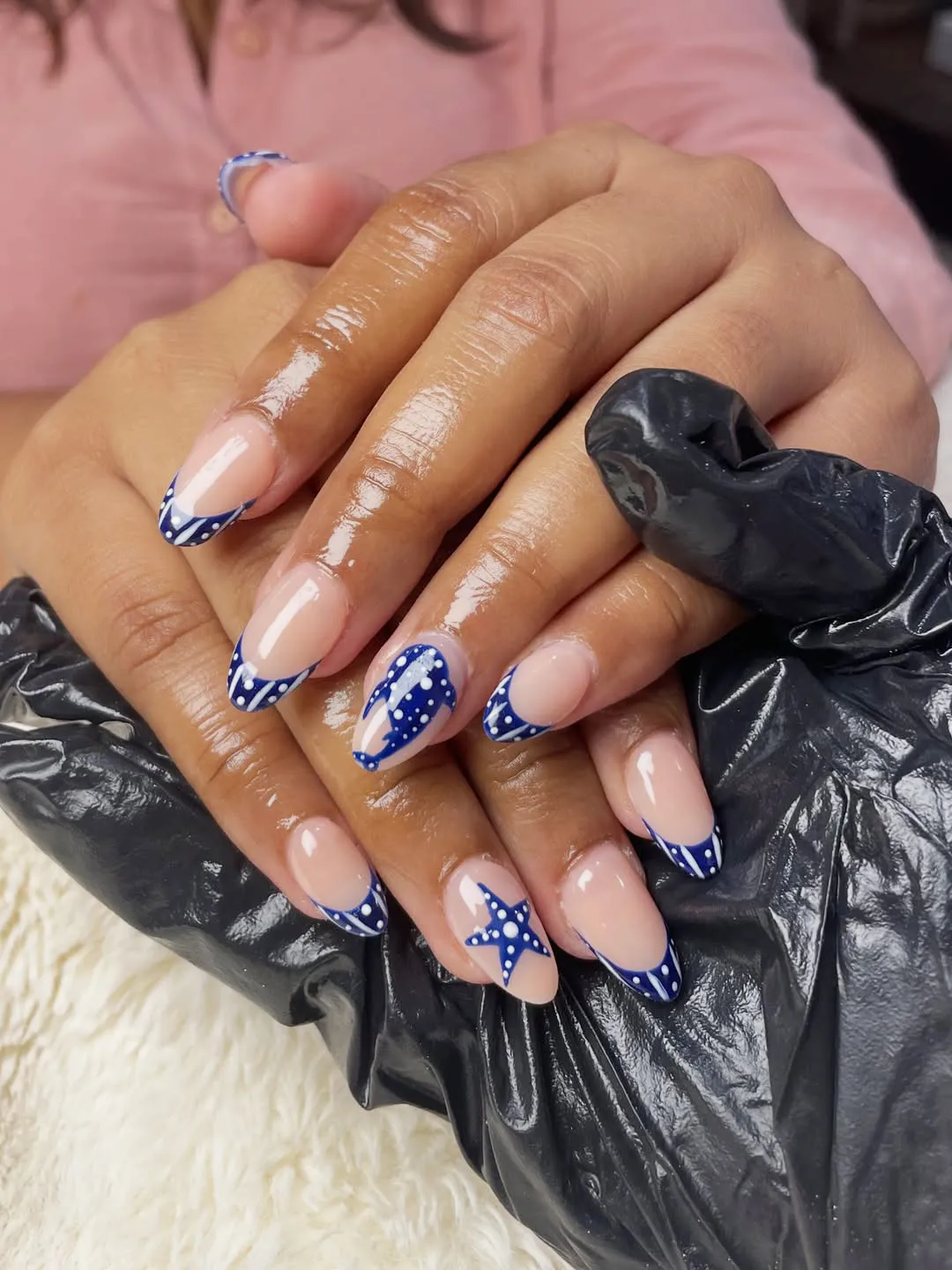 Nude-and-navy dotted French tips with star accent