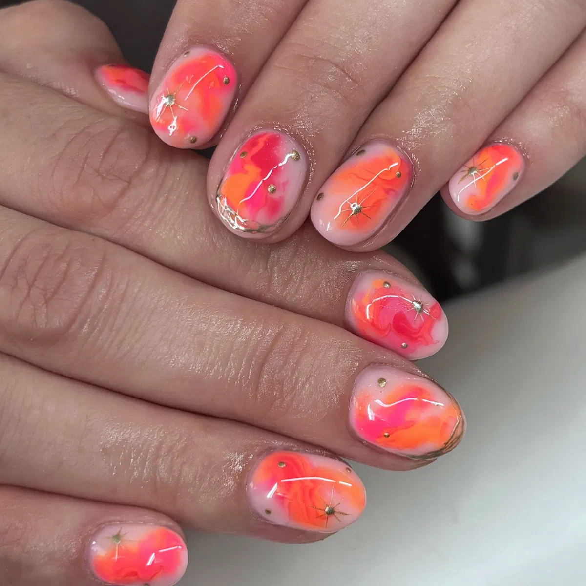 Abstract orange-pink marbling with tiny studs