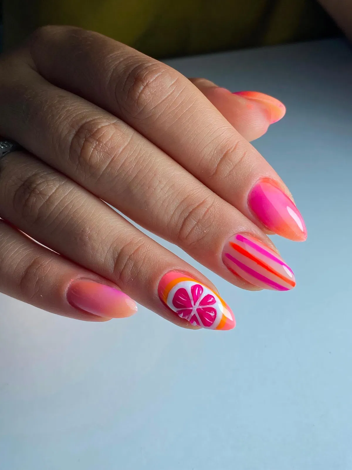 Pink-orange ombrรฉ with stripes and citrus-slice accent