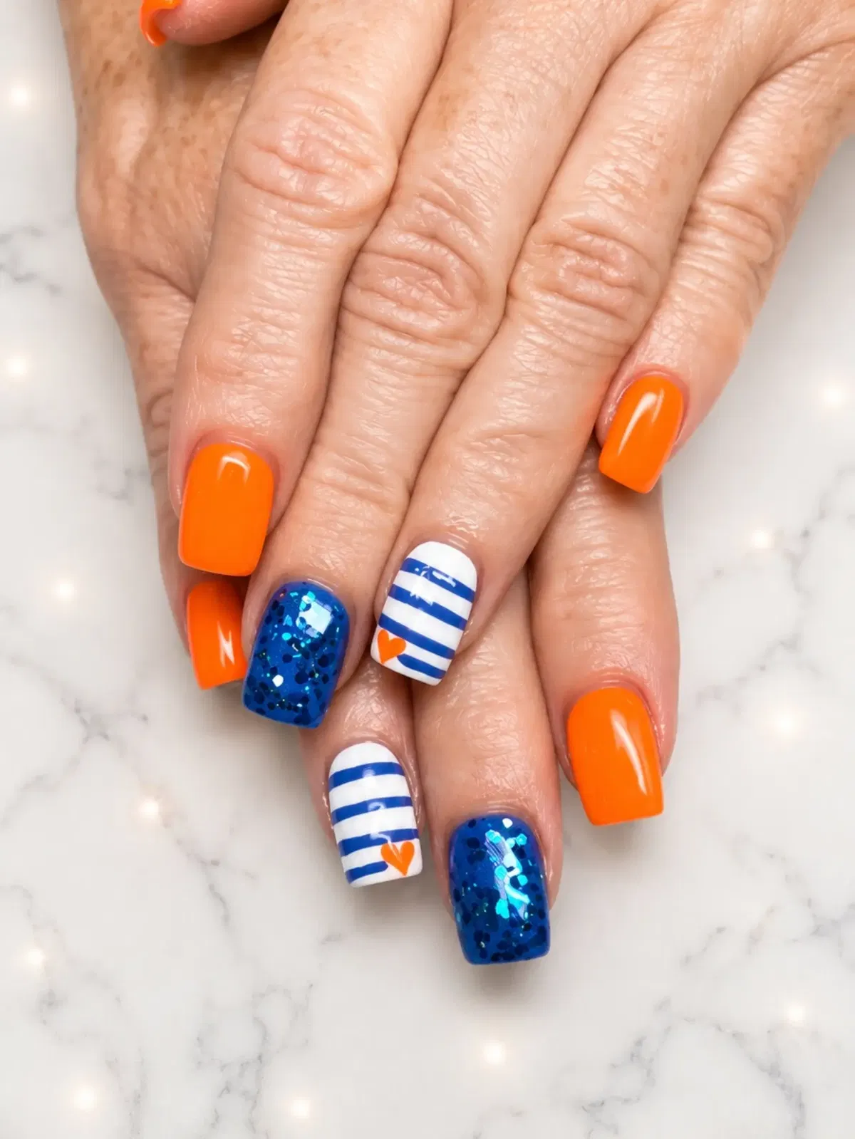 Bright orange solids with blue glitter and striped heart accents