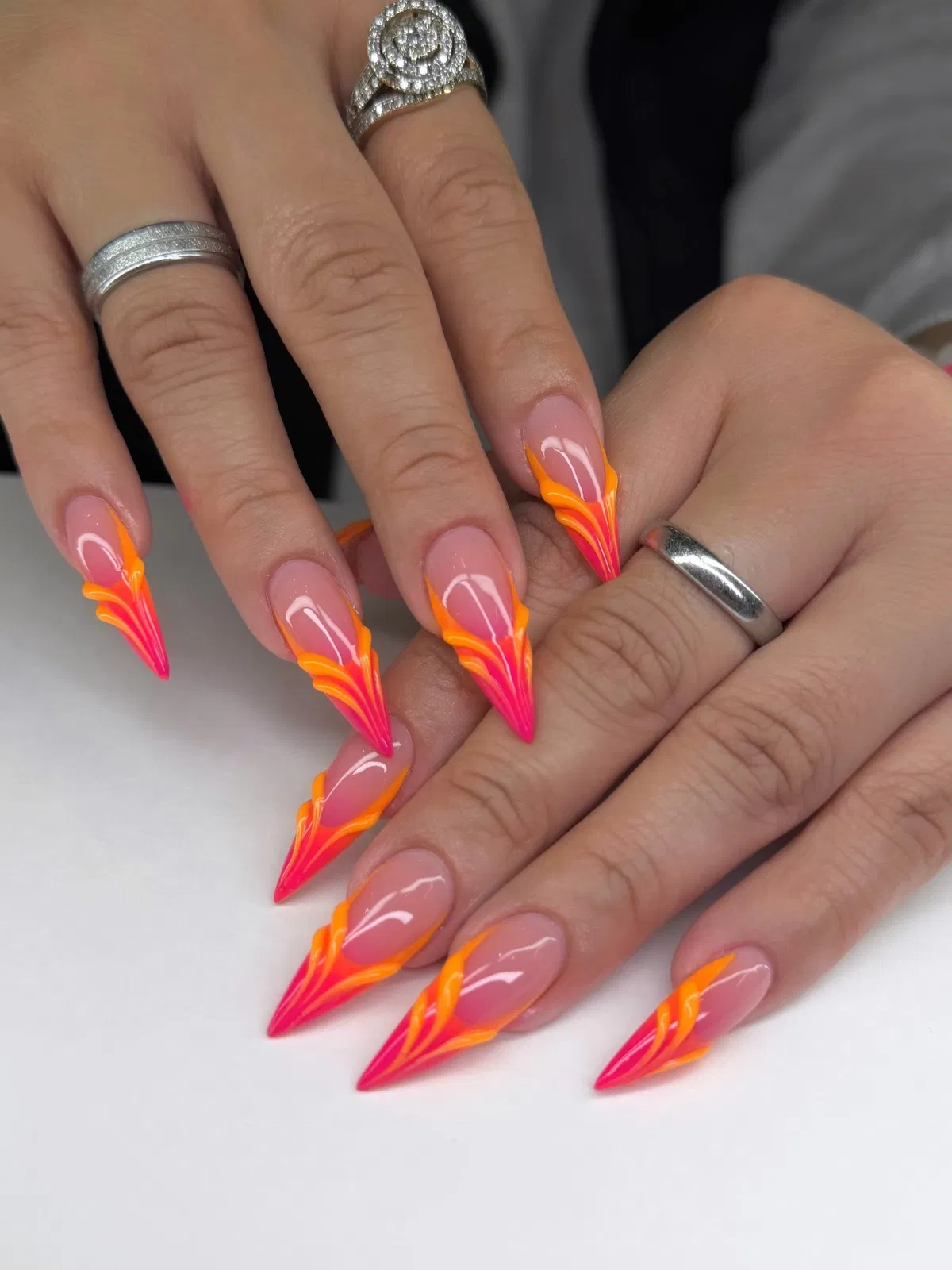 Long stiletto flame-line tips in orange and pink