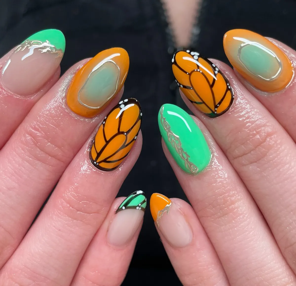 Orange-black graphic sections with green and metallic outlines