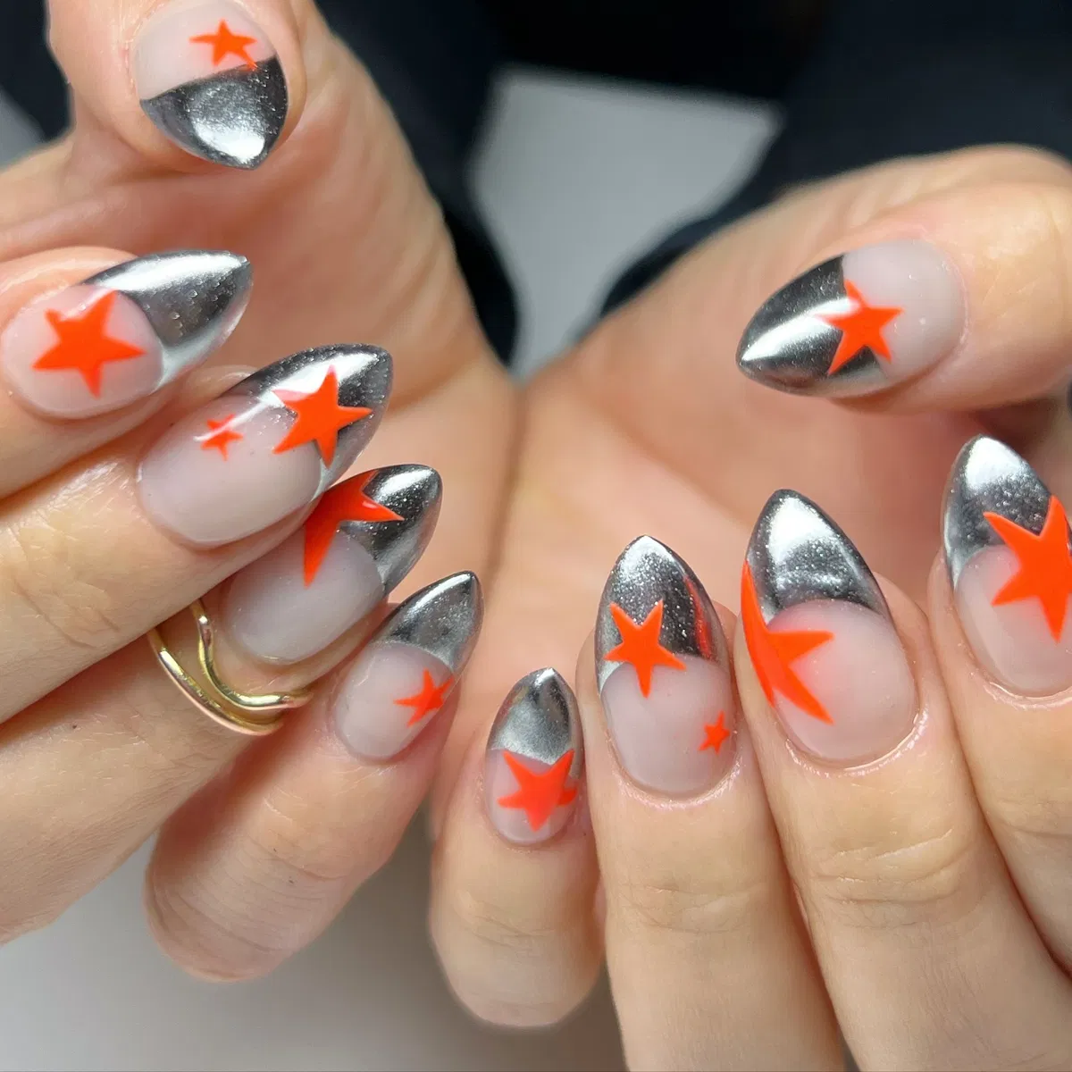 Silver metallic tips with bright orange star accents