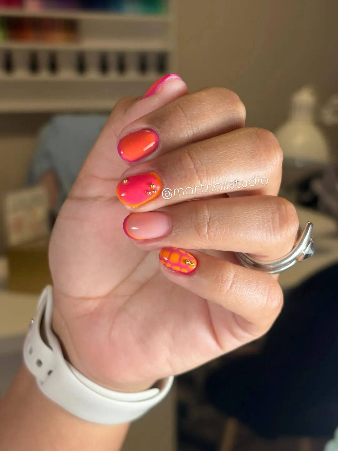 Orange-pink gradients with grid accent and gold studs