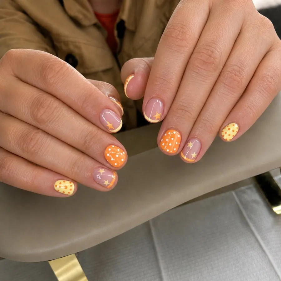 Short orange dots with star accent nails