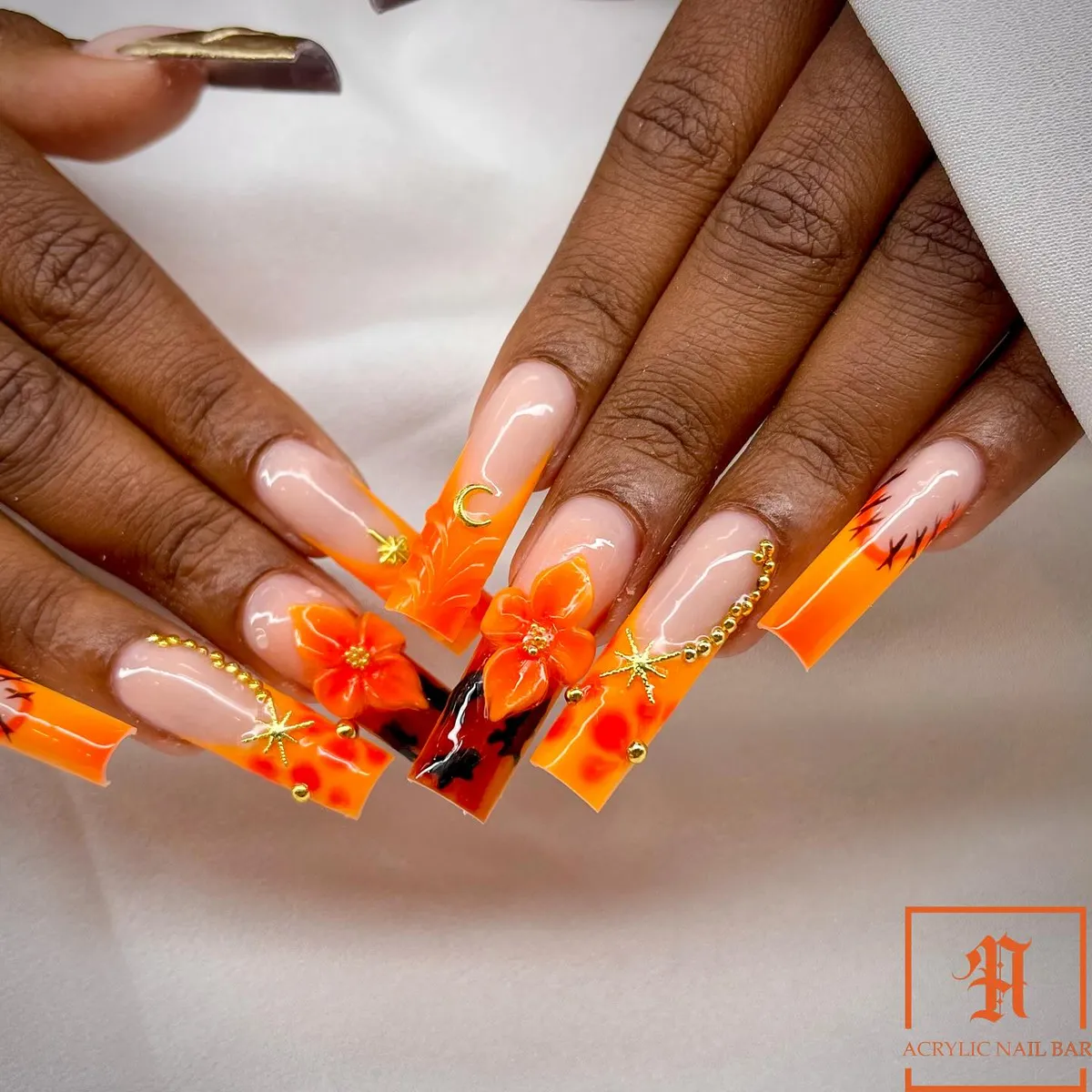Orange French Tips with 3D Flowers and Gold Charms