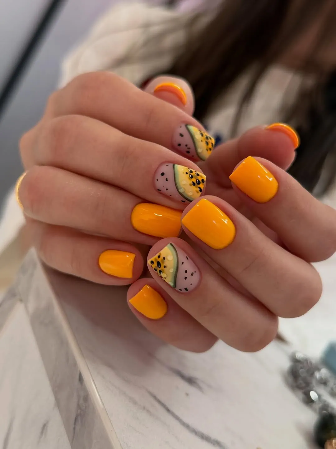 Yellow-orange nails with fruit-slice wedge accents