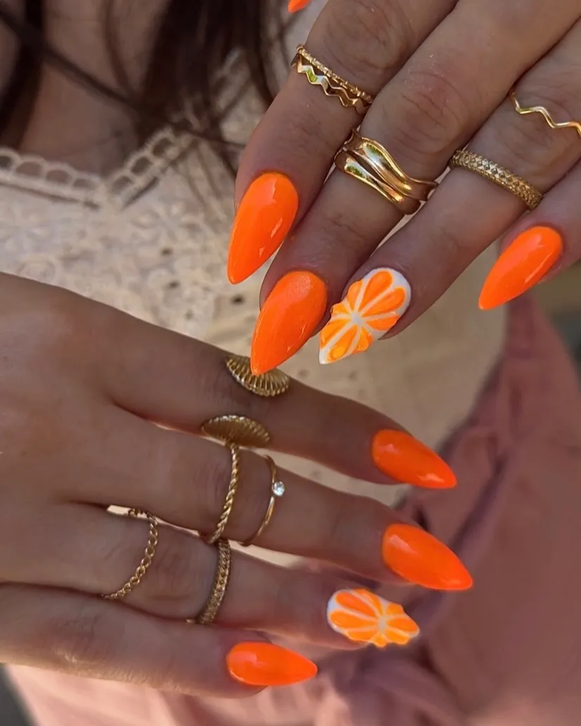 Solid bright orange with citrus-slice accent nails