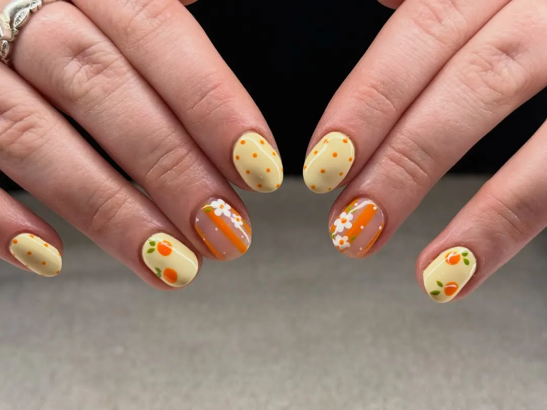 Pale yellow polka dots with orange stripes and floral accents