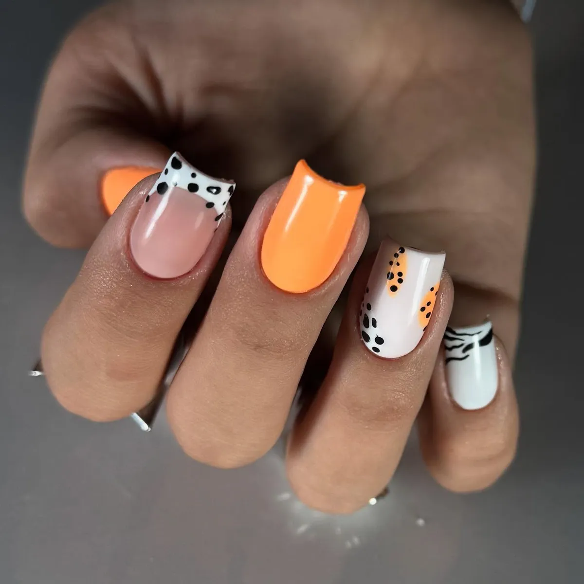 Orange accent with black-and-white polka dot tips