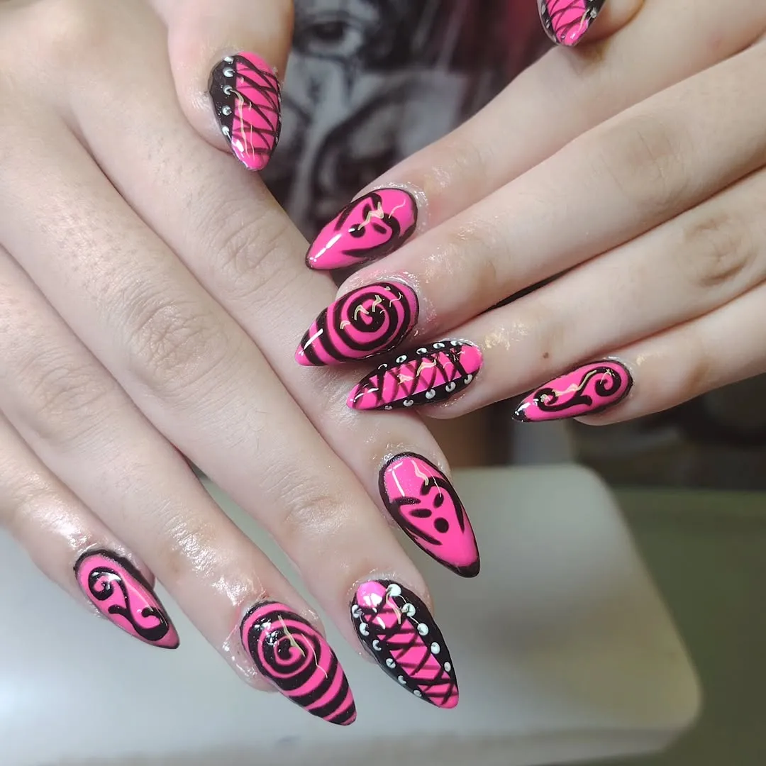 Hot Pink Stiletto Nails with Black Swirls and Stud Accents