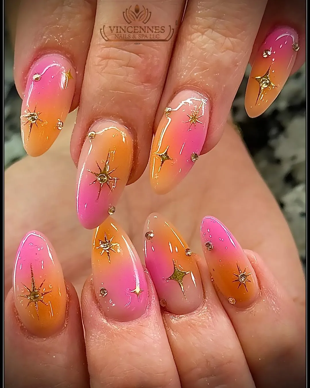 Pink-orange ombrΓ© with gold starbursts and studs