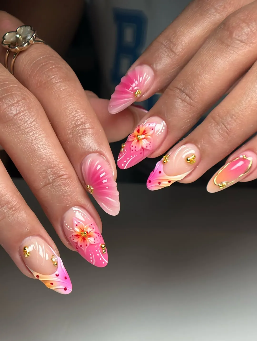 Nude base with pink-orange gradients, 3D flowers, and gold accents