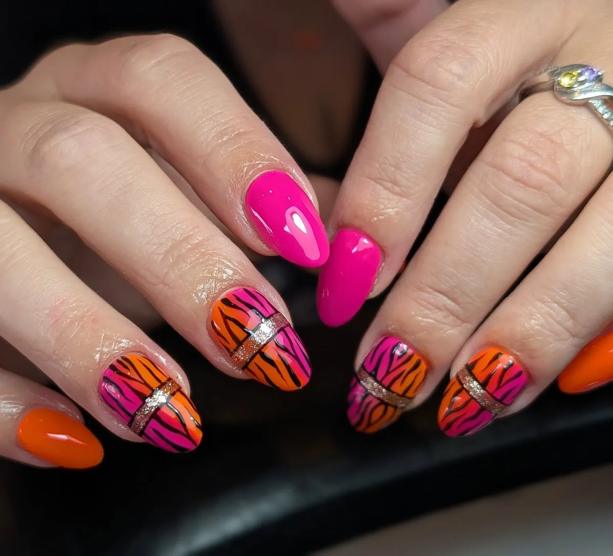 Hot pink and orange zebra-stripe nails with glitter bands