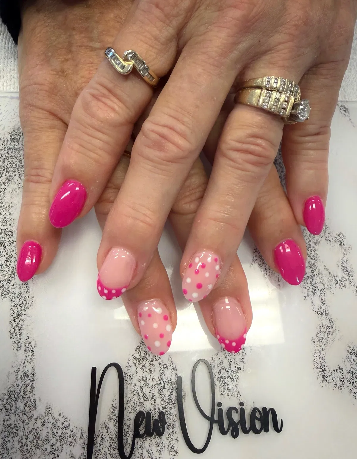Bright pink solids with polka-dot accent nails