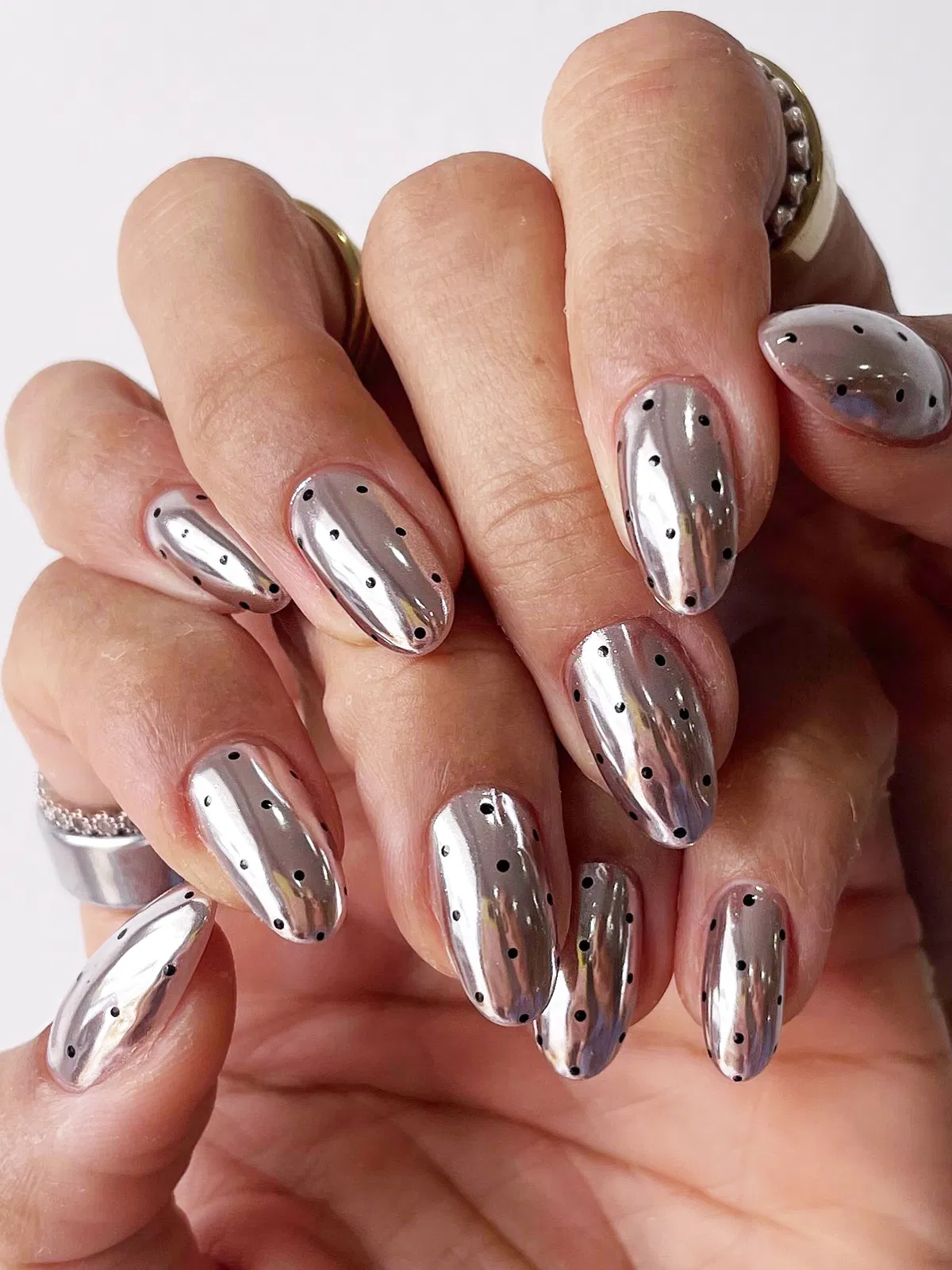 Mirror-like silver nails with black polka dots